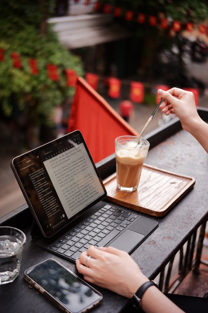 outdoor-cafe-workspace-with-tablet-and-coffee-34769799